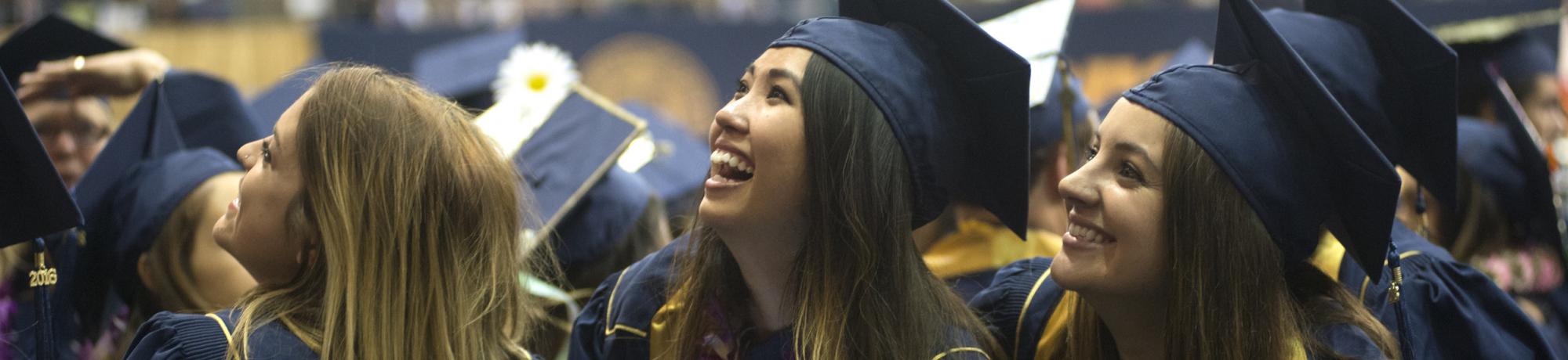 Students call to friends as they walk into the Pavilion during the commencement on Friday June 10, 2016 at UC Davis.